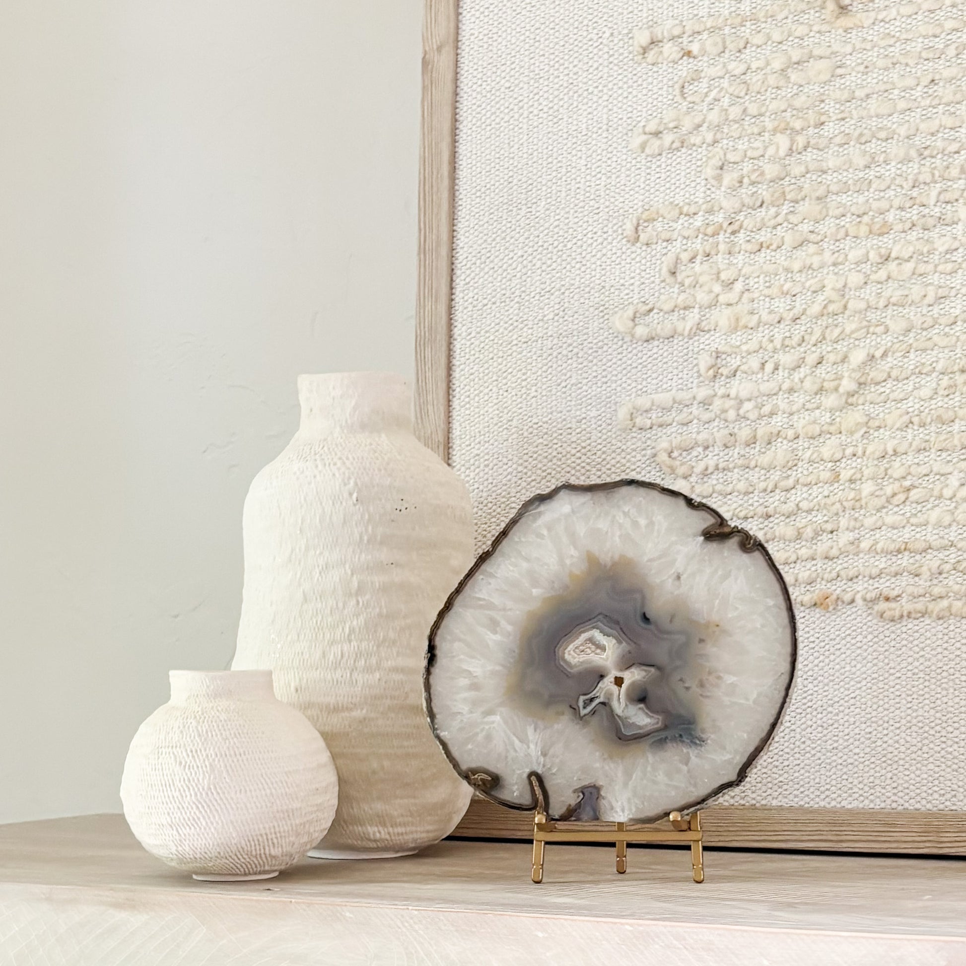 Decorative Brazilian agate crystal slice on stand adding natural beauty and sophistication to interior spaces.