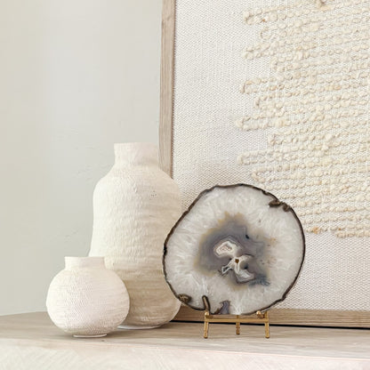 Decorative Brazilian agate crystal slice on stand adding natural beauty and sophistication to interior spaces.