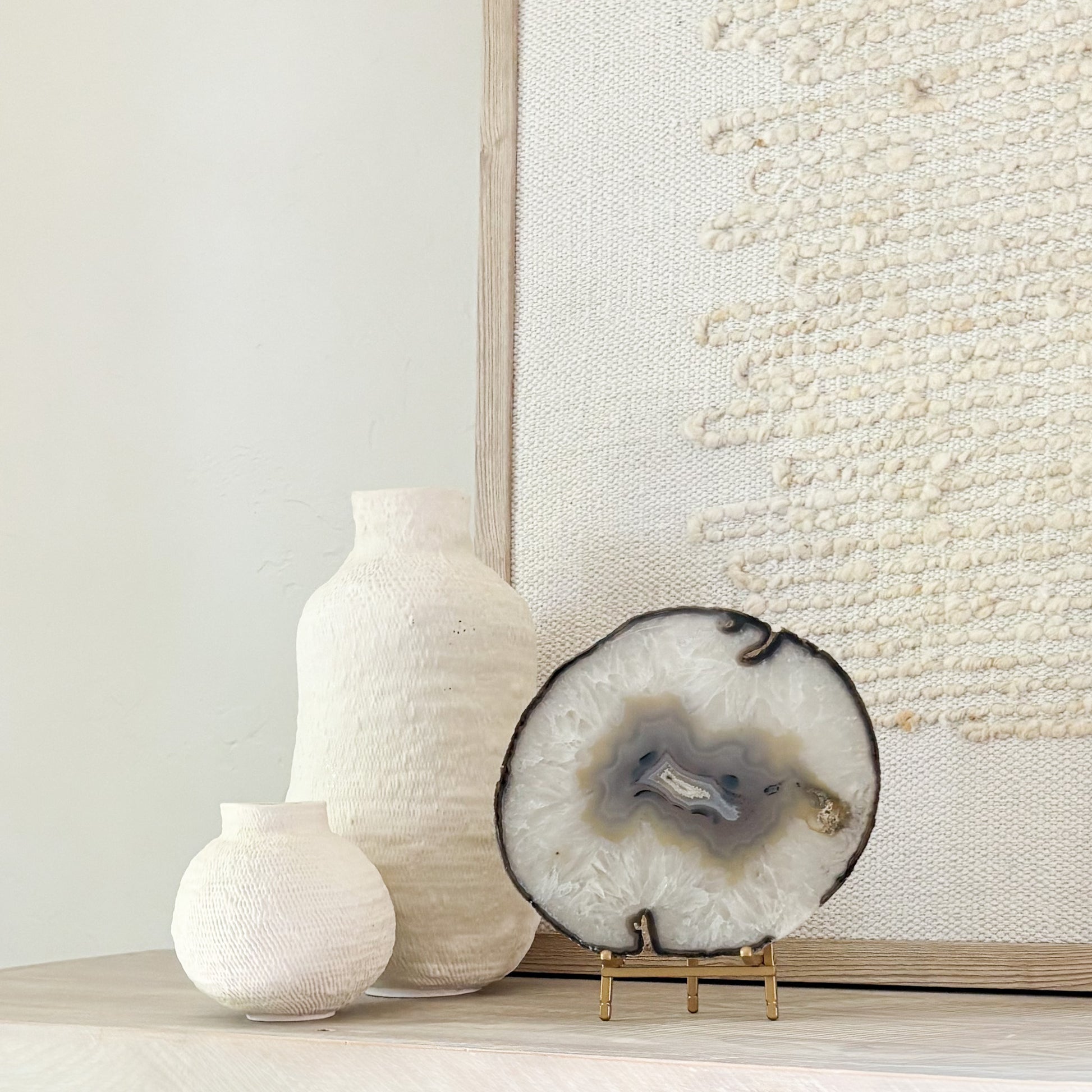 Natural Brazilian agate slice art displayed on stand, blending organic beauty with contemporary interior design.