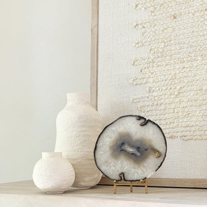 Natural Brazilian agate slice art displayed on stand, blending organic beauty with contemporary interior design.