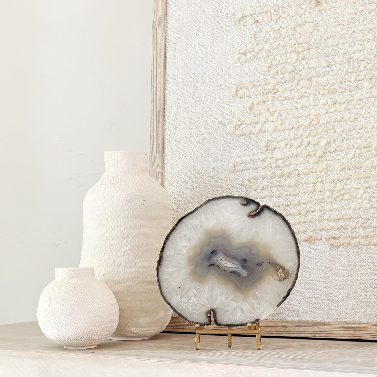 Brazilian agate stone slice mounted on metal stand, a striking natural accent for living room décor.