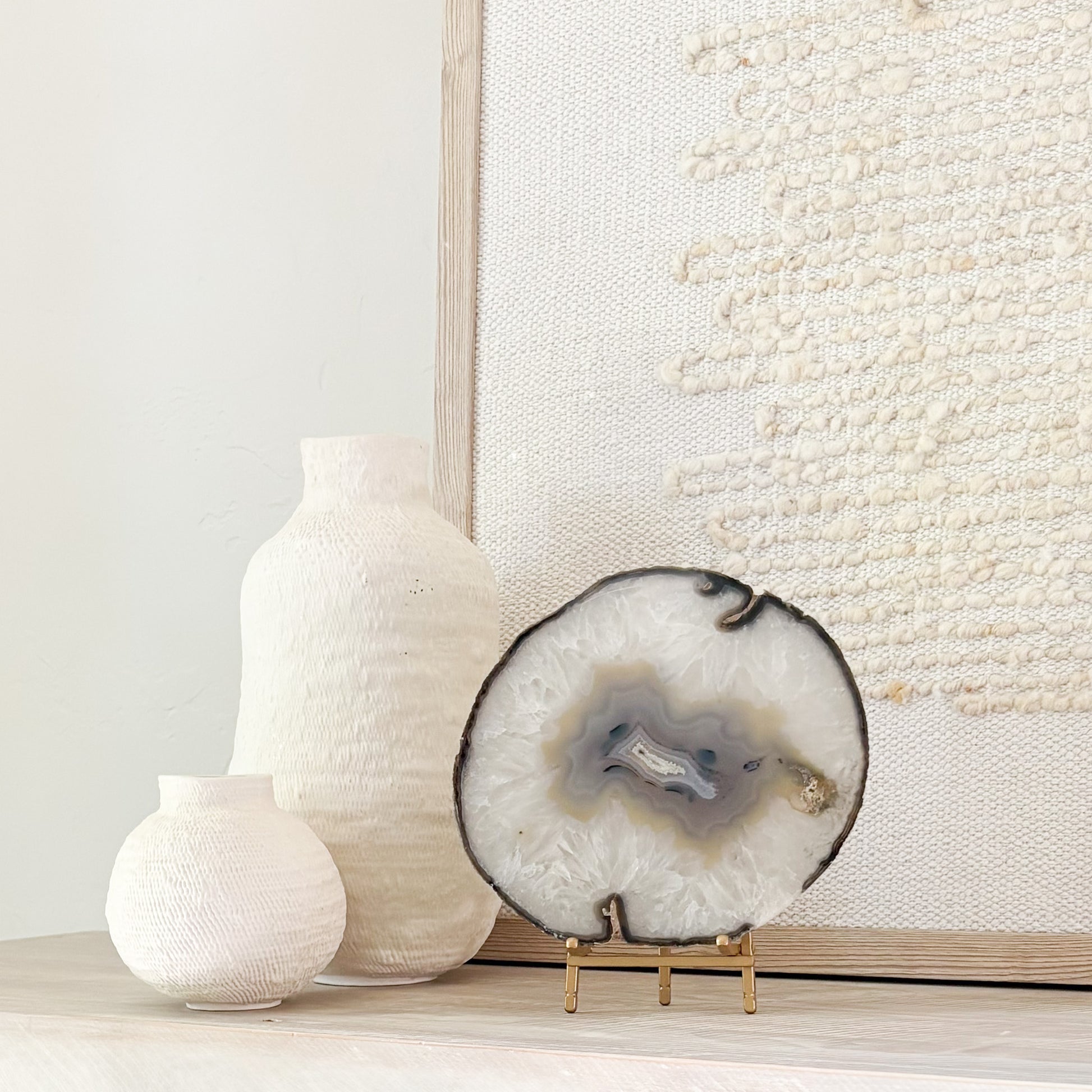 Brazilian agate stone slice mounted on metal stand, a striking natural accent for living room décor.
