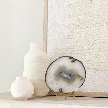 Brazilian agate stone slice mounted on metal stand, a striking natural accent for living room décor.