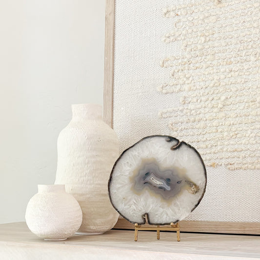 Brazilian agate stone slice mounted on metal stand, a striking natural accent for living room décor.