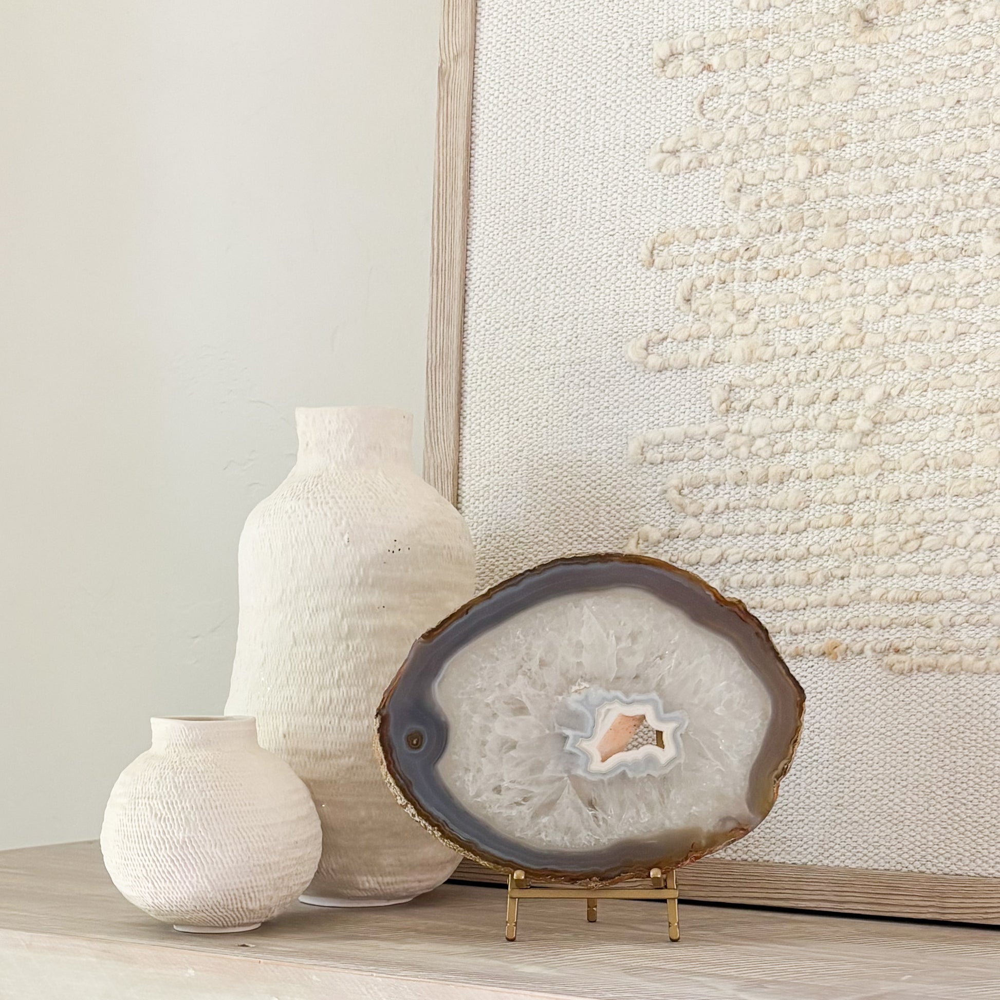 Decorative Brazilian agate crystal slice on stand adding natural beauty and sophistication to interior spaces.