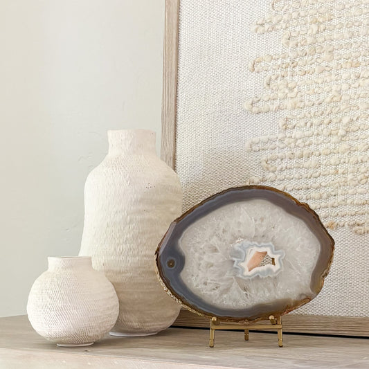 Brazilian agate slice on metal stand displaying natural crystal patterns as elegant home décor accent.