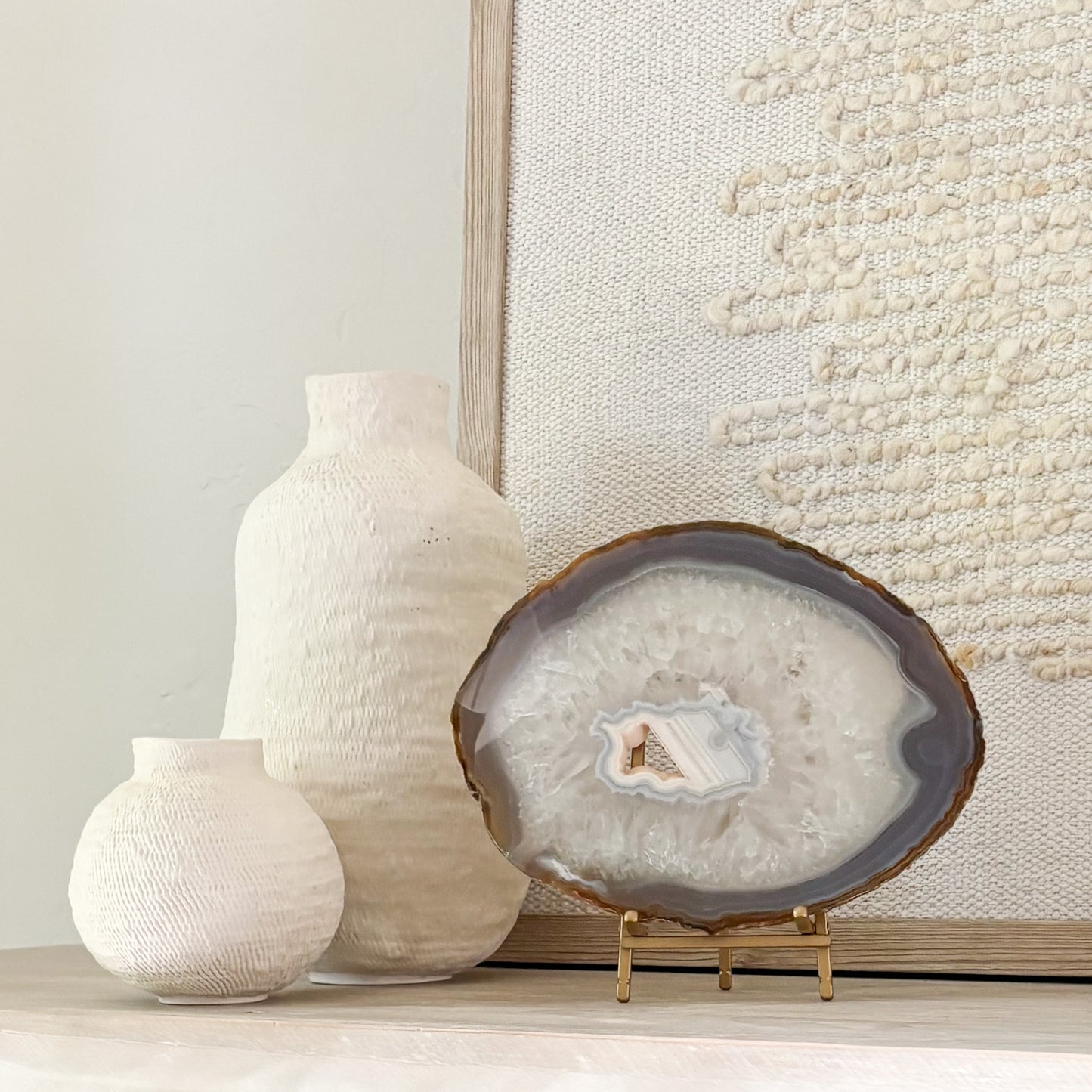 Polished Brazilian agate slice with unique banding on decorative stand for modern home décor.