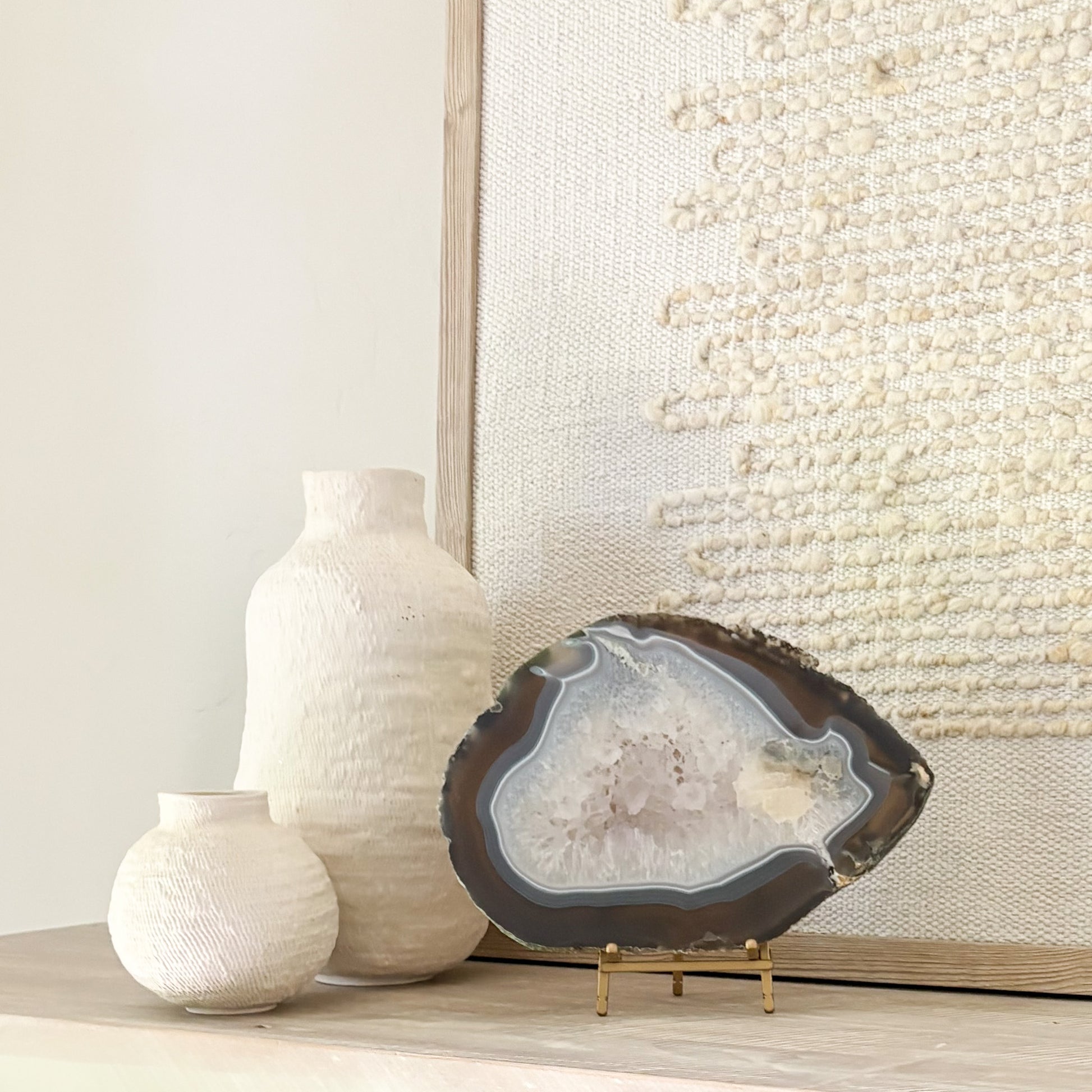 Large Brazilian agate slice sculpture on stand showcasing intricate geological formations for home decoration.