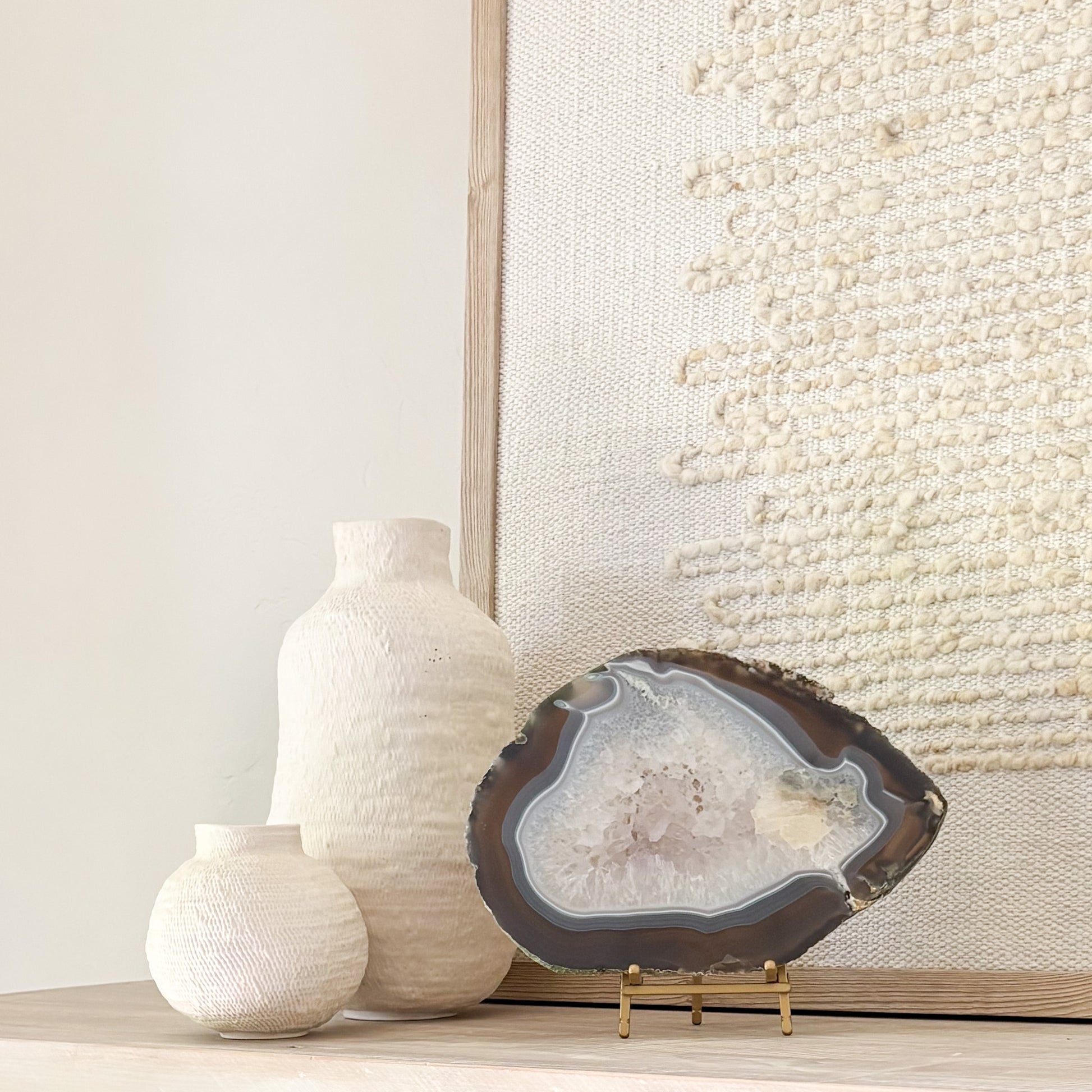 Brazilian agate stone slice mounted on metal stand, a striking natural accent for living room décor.