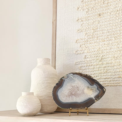 Brazilian agate stone slice mounted on metal stand, a striking natural accent for living room décor.