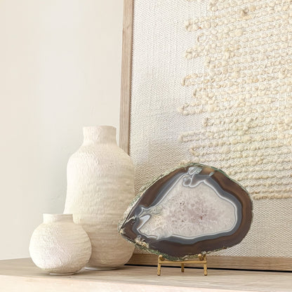 Decorative Brazilian agate crystal slice on stand adding natural beauty and sophistication to interior spaces.