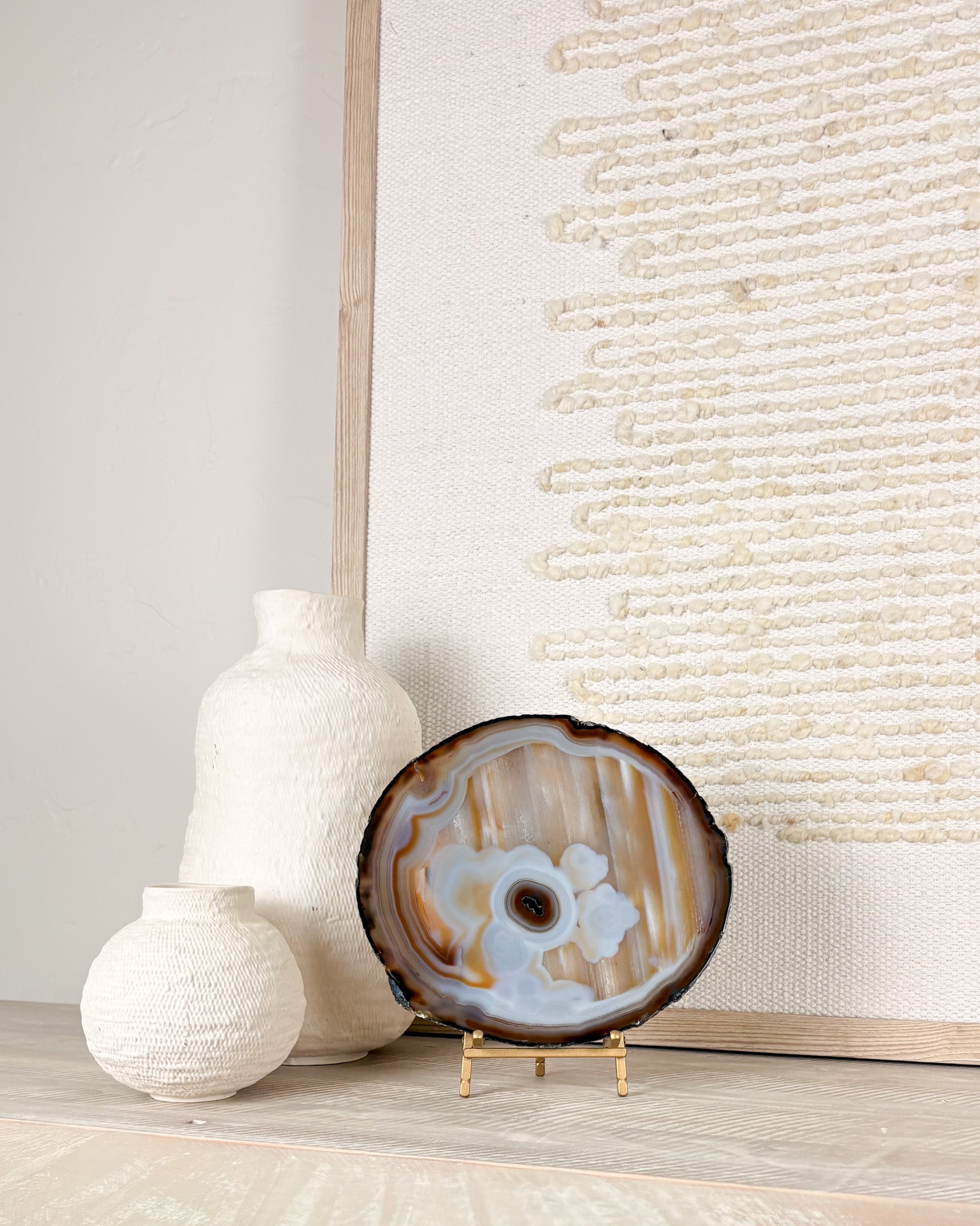 Brazilian agate crystal slice on display stand featuring natural banded stone formations