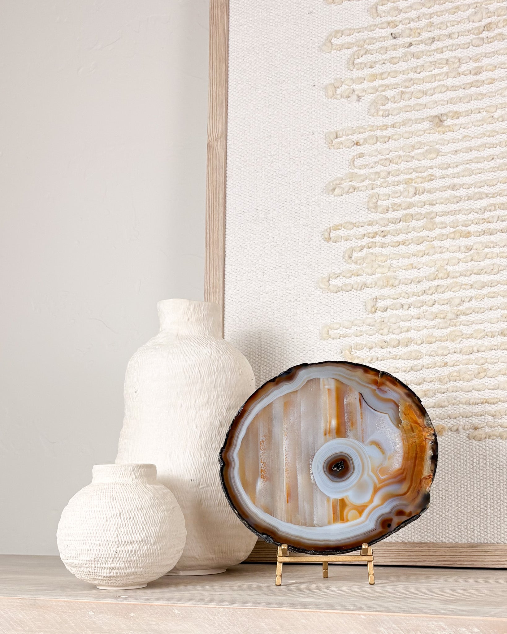 Brazilian agate geode slice on stand featuring polished edges and natural crystal formations.