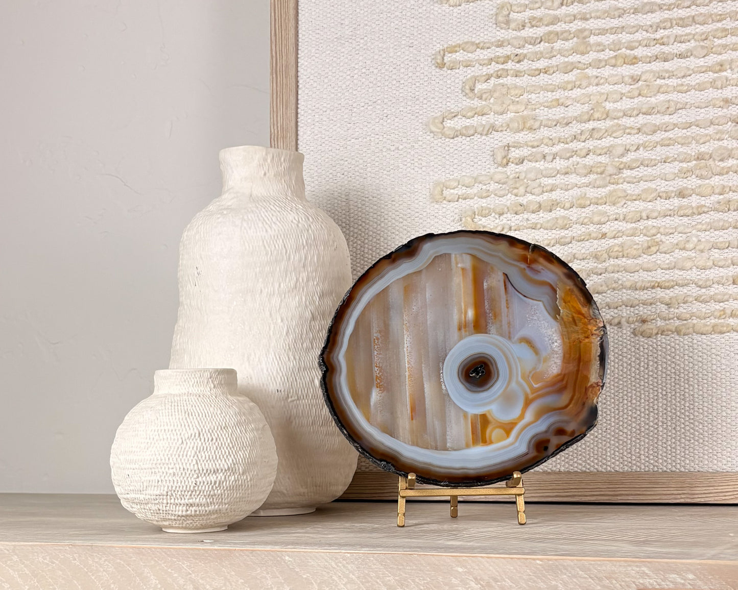 Natural Brazilian agate slice on stand with polished crystal bands and unique gemstone patterns