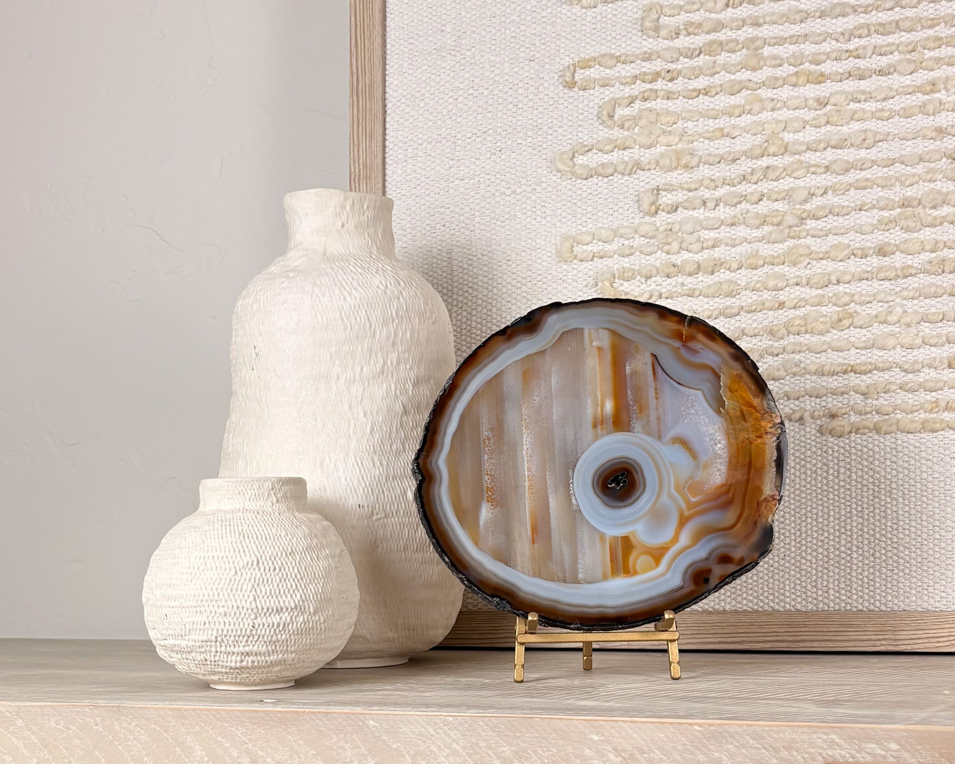 Natural Brazilian agate slice on stand with polished crystal bands and unique gemstone patterns