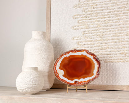 “Natural Brazilian agate slice on stand with polished crystal bands and unique gemstone patterns"
