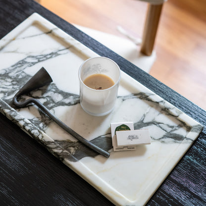 White Calacatta Borghini marble serving tray with bold natural veining and decorative accents