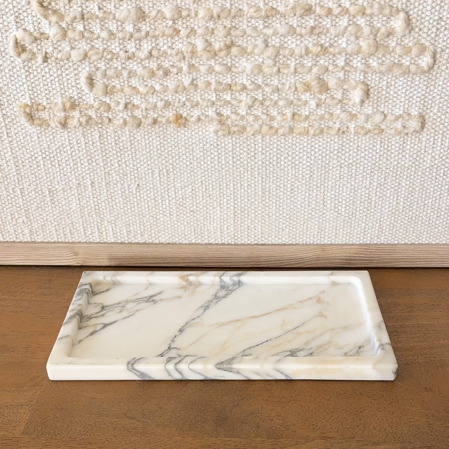 Angled view of Calacatta Vagli marble tray with natural gray veining