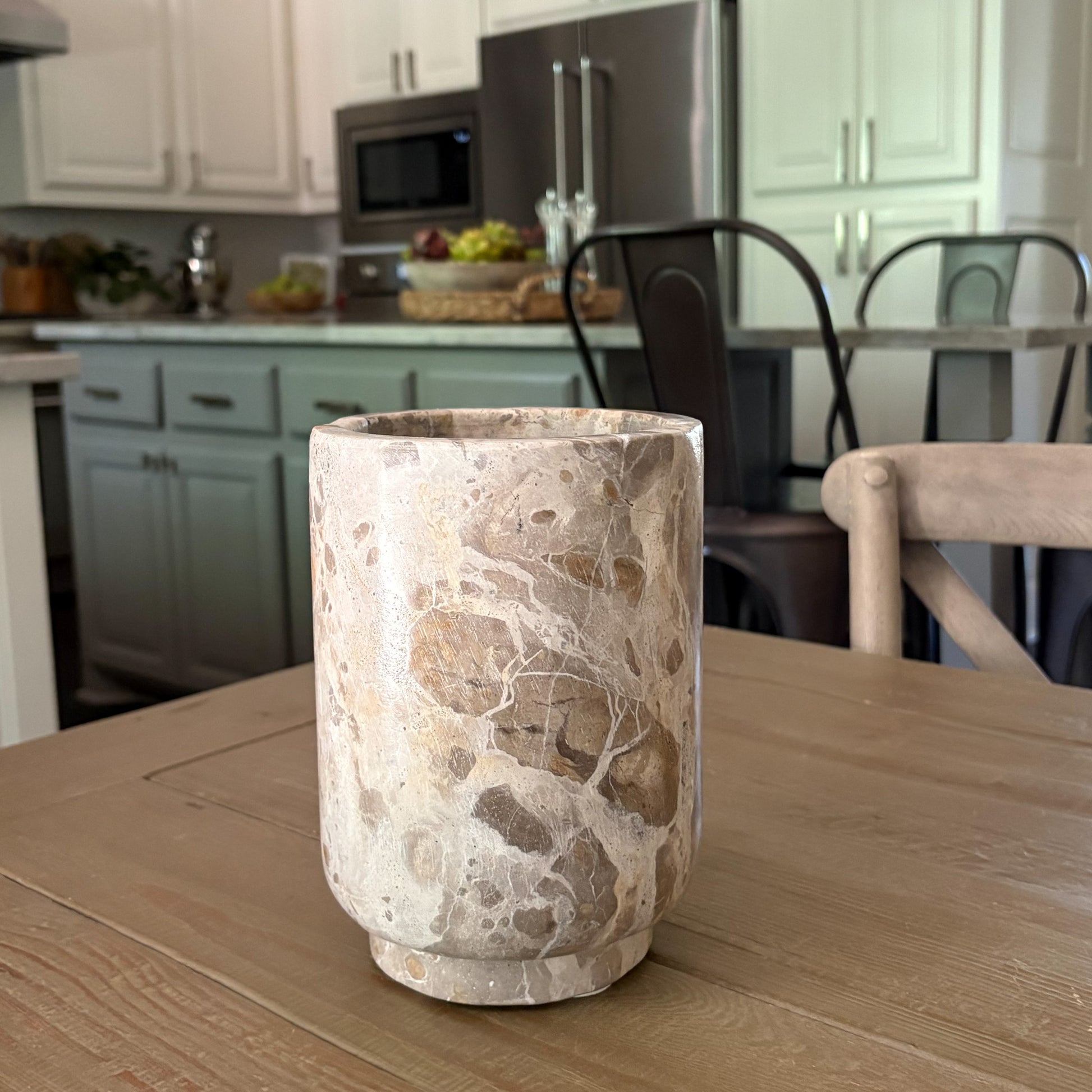 Handcrafted marble wine cooler keeping rosé chilled on a dining table