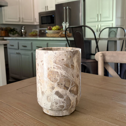 Handcrafted marble wine cooler keeping rosé chilled on a dining table