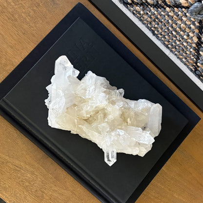 Natural crystal cluster displayed in calm neutral home environment