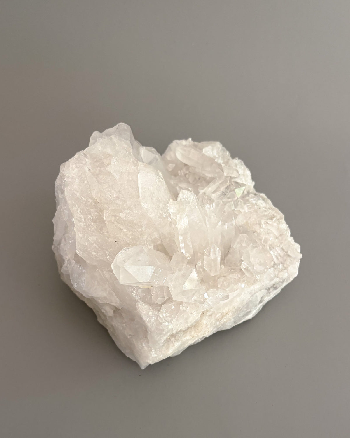 Natural clear quartz mineral specimen with sparkling crystal points and organic formations.