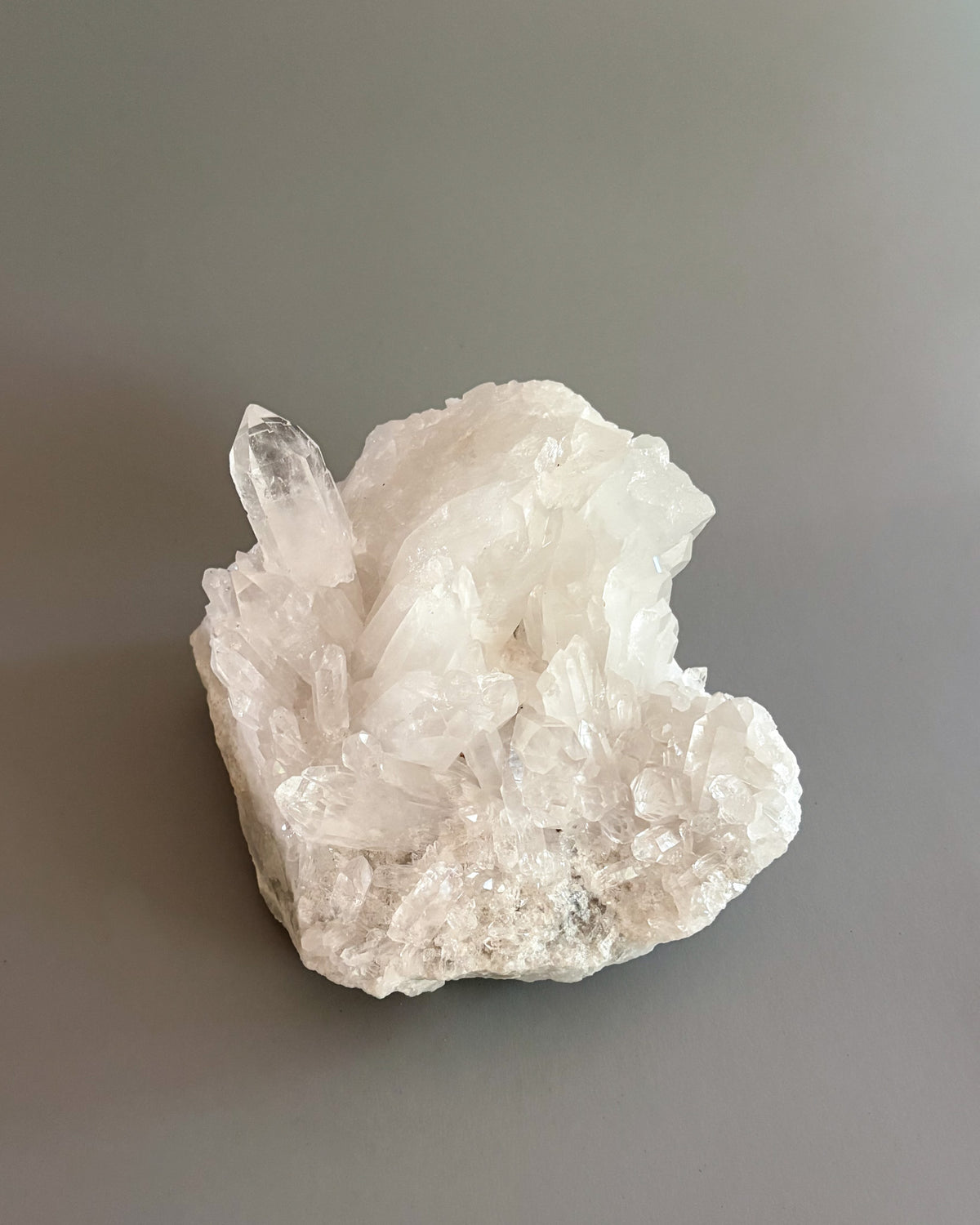 Clear quartz crystal cluster showcasing varied crystal sizes, translucent surfaces, and natural details.