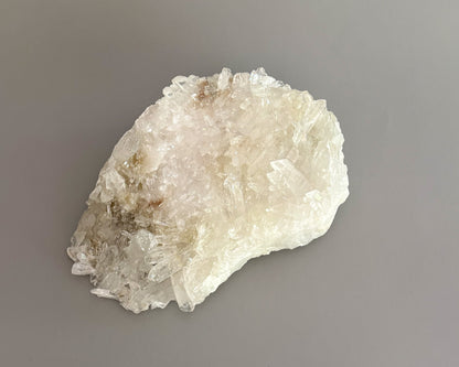 Natural clear quartz crystal cluster with translucent points and unique crystalline formations.