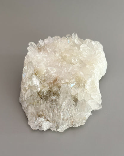 Clear quartz crystal cluster featuring naturally formed transparent and milky white crystal points.