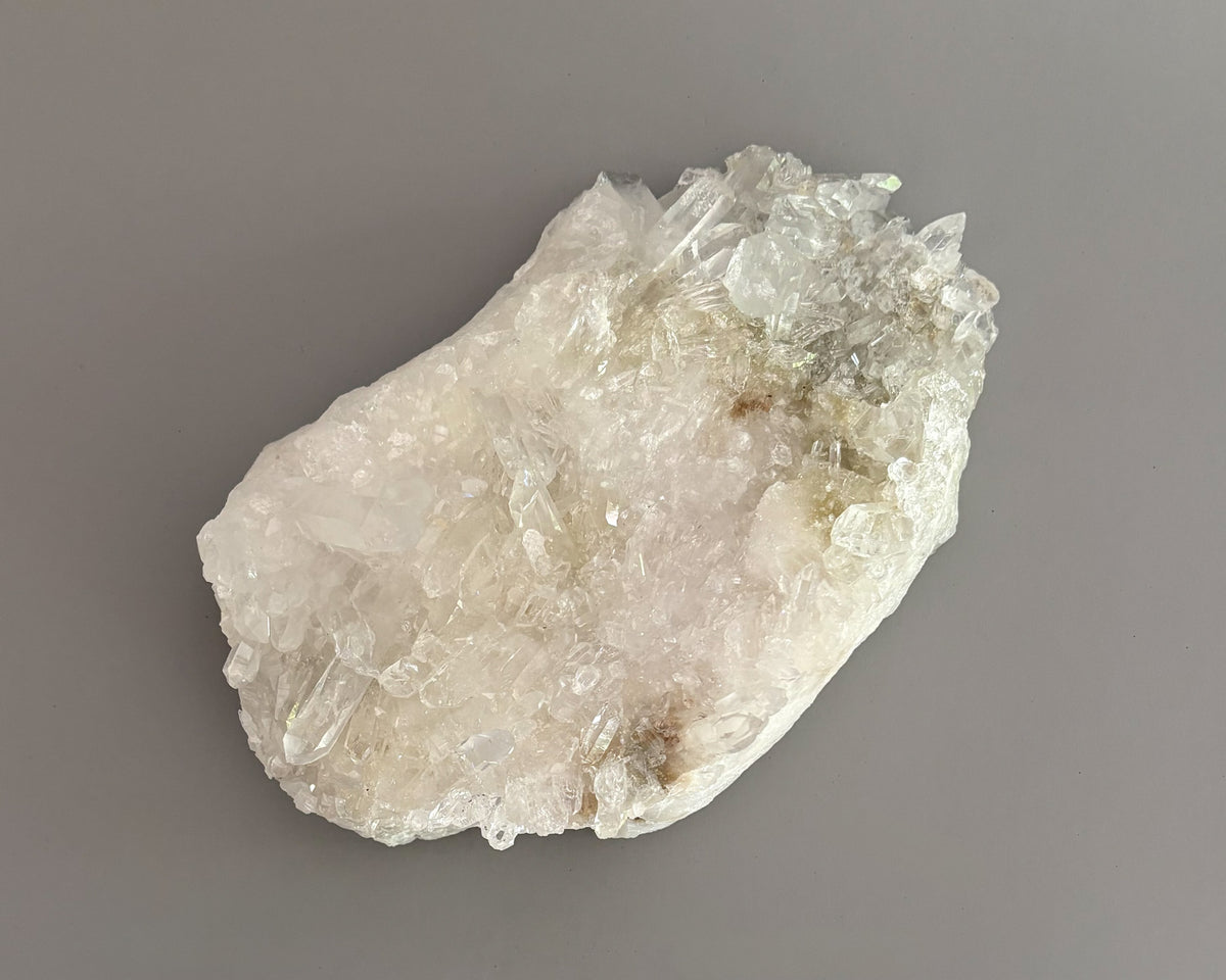 Clear quartz crystal cluster showcasing varied crystal sizes, translucent surfaces, and natural details.
