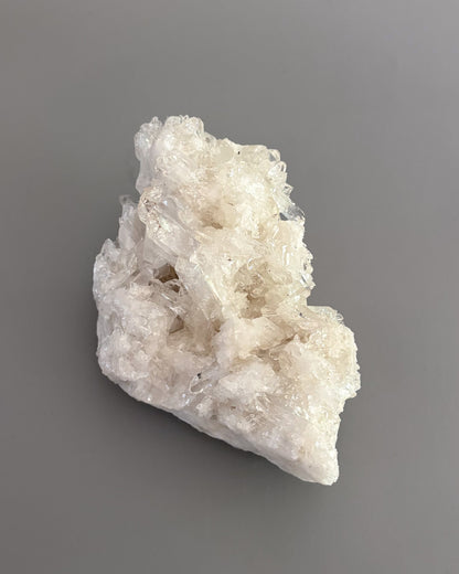 Clear quartz crystal cluster showcasing varied crystal sizes, translucent surfaces, and natural details.