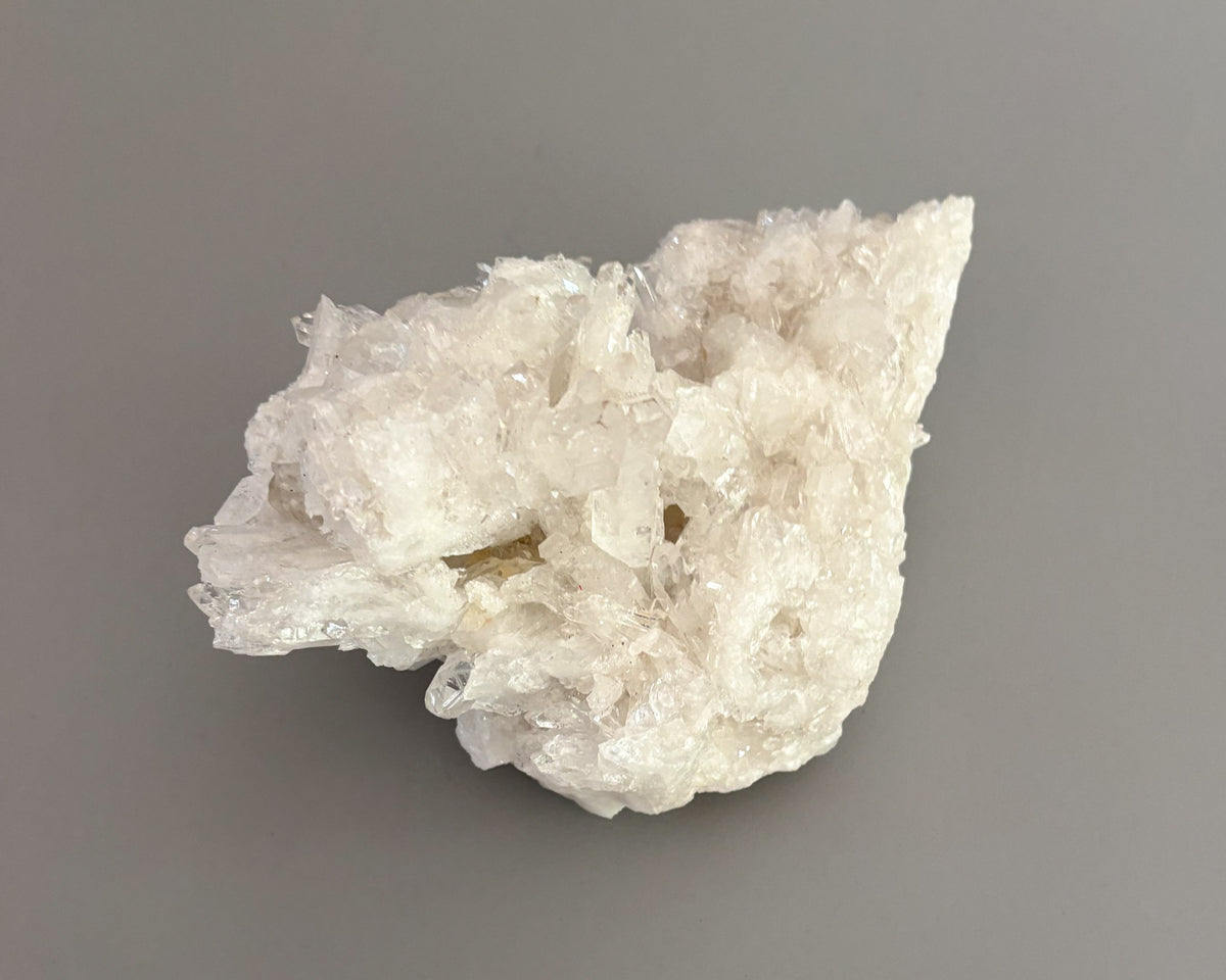 Clear quartz crystal cluster featuring naturally formed transparent and milky white crystal points.