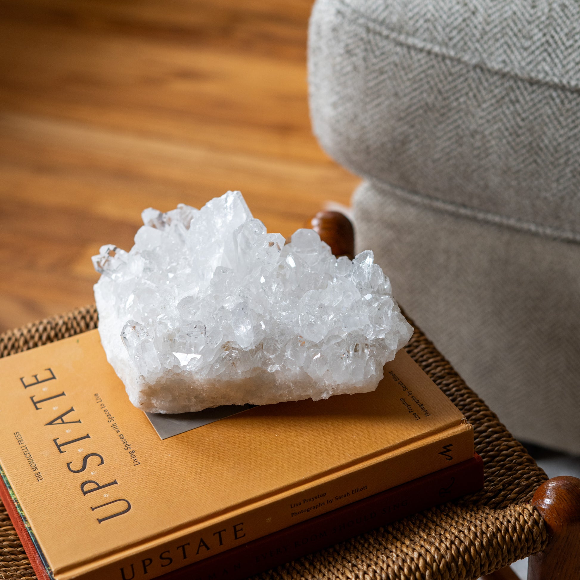 Natural clear quartz crystal cluster displayed as artisanal luxury home decor with raw sparkling crystal points