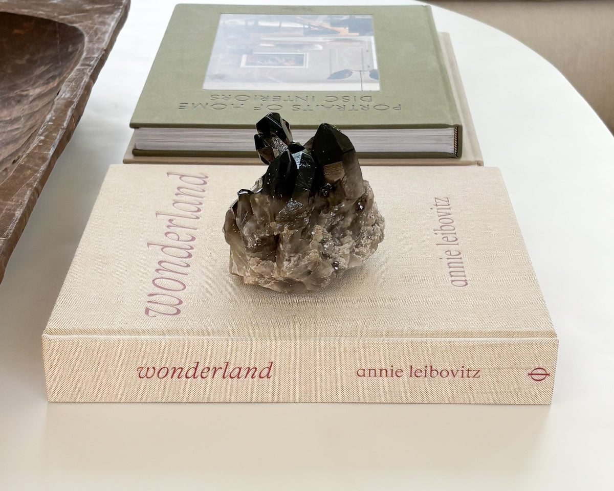Natural smoky quartz cluster displayed as sculptural stone decor