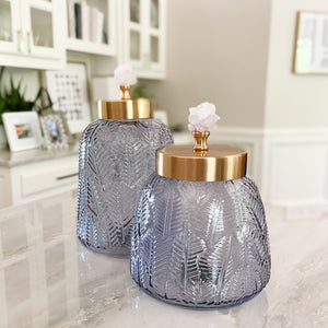 decorative blue-grey glass canisters with pink crystal handle
