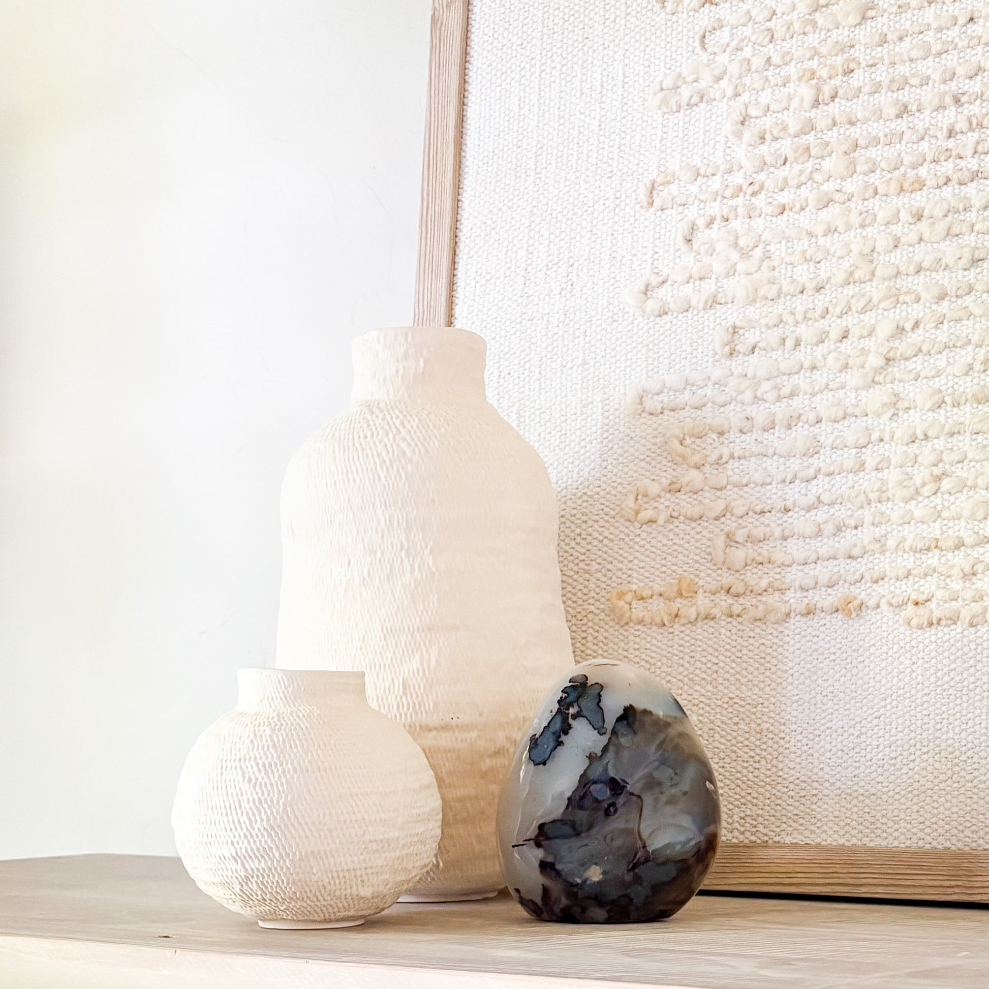 Luxury fern agate crystal sculpture with botanical-like inclusions on neutral styled shelf
