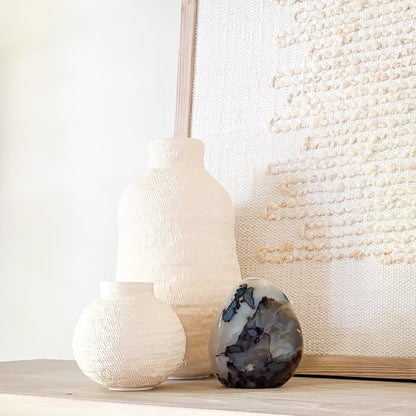 Luxury fern agate crystal sculpture with botanical-like inclusions on neutral styled shelf