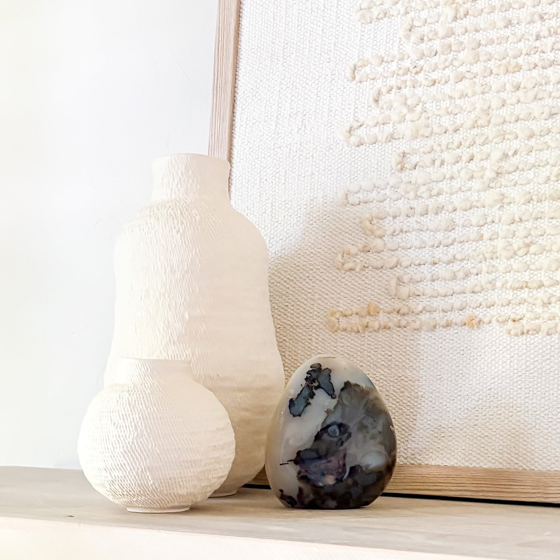 Madagascar fern agate sculpture with natural ink-like inclusions styled in neutral minimalist interior