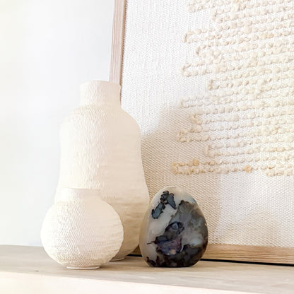 Madagascar fern agate sculpture with natural ink-like inclusions styled in neutral minimalist interior