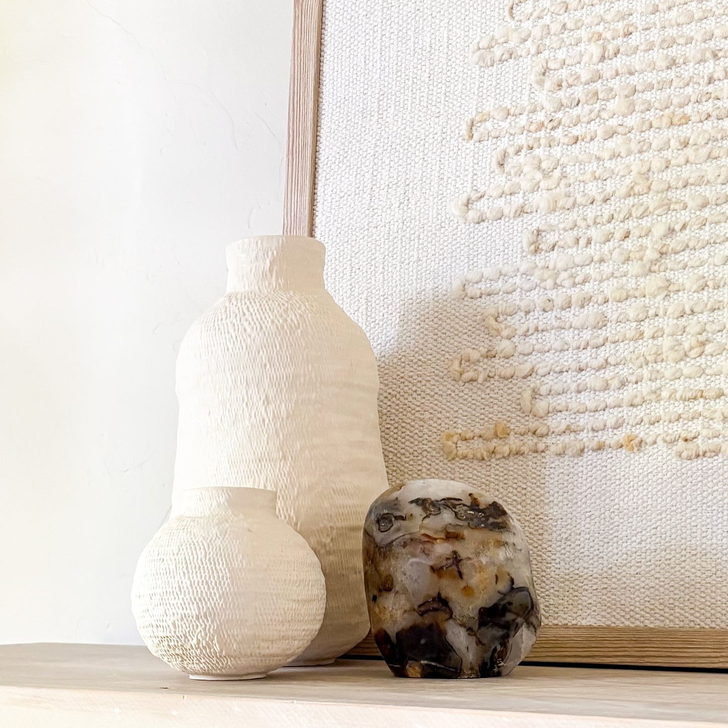 Collector-grade fern agate sculpture with soft translucent tones and dark organic inclusions