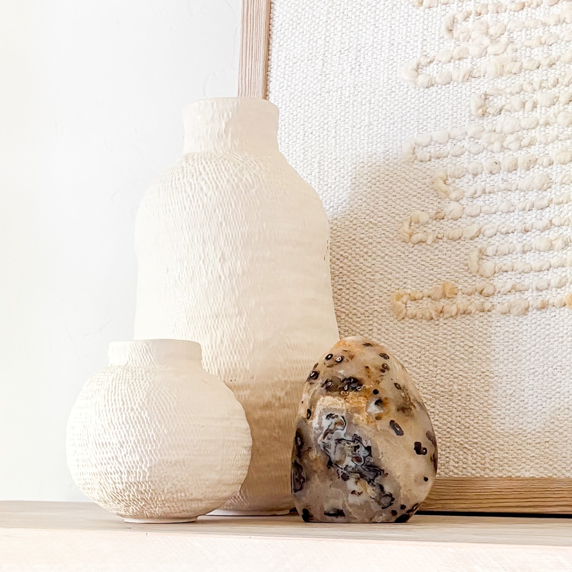 Madagascar fern agate sculpture with natural ink-like inclusions styled in neutral minimalist interior