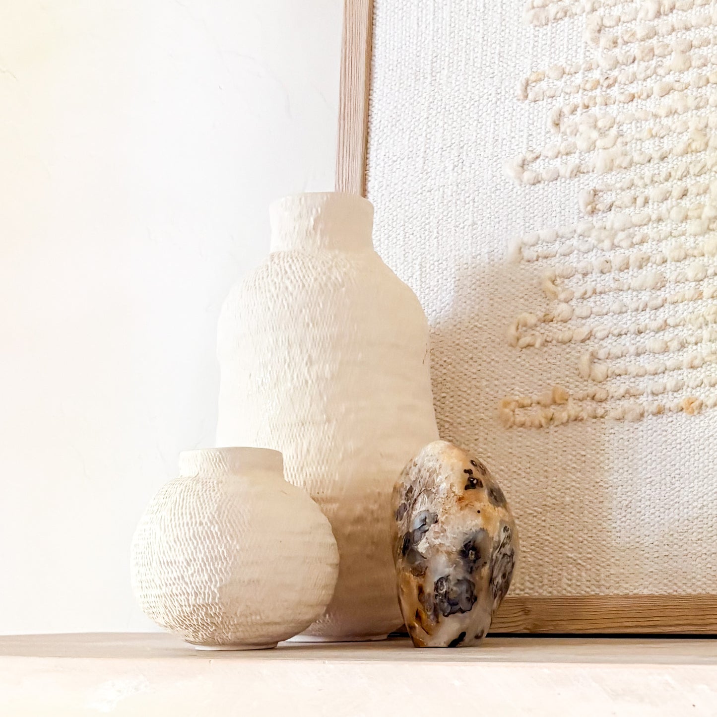 Luxury fern agate crystal sculpture with botanical inclusions on neutral styled shelf