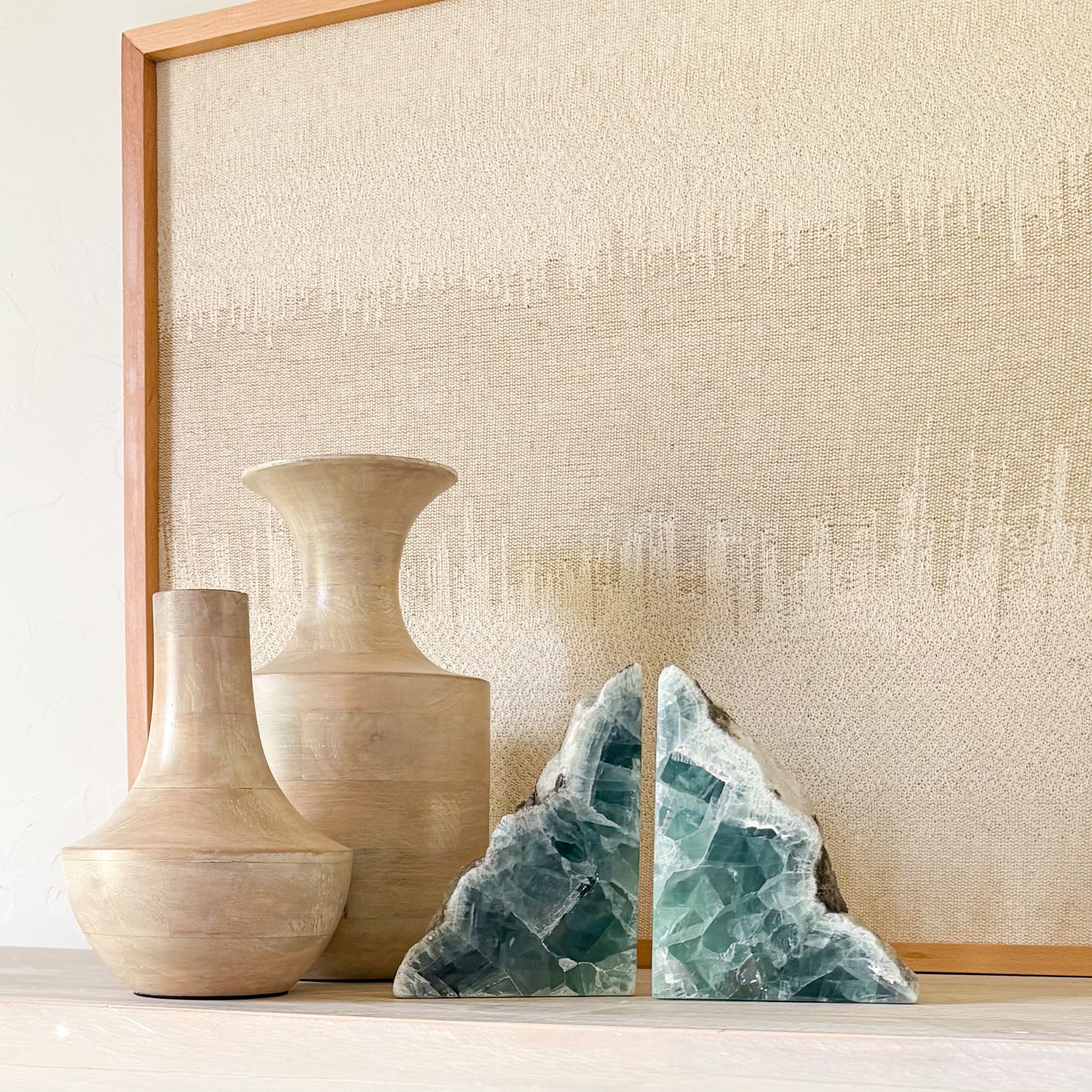 Luxury gemstone bookends in green fluorite styled with earthy wood decor