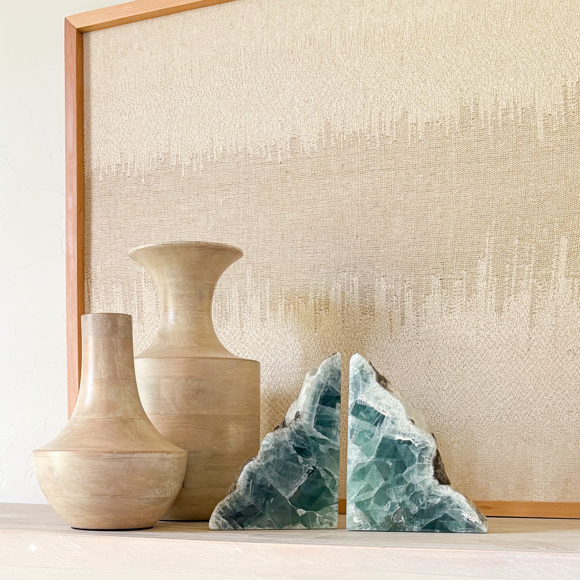 Luxury gemstone bookends in green fluorite styled with earthy wood decor