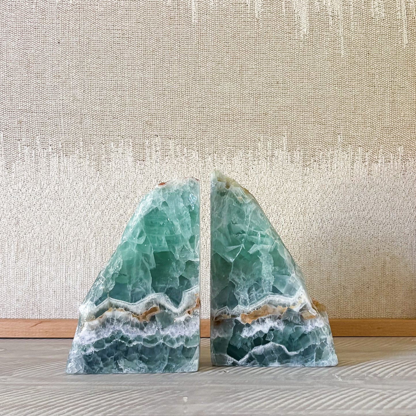 Natural rainbow fluorite bookends with smooth cut base and raw crystal top