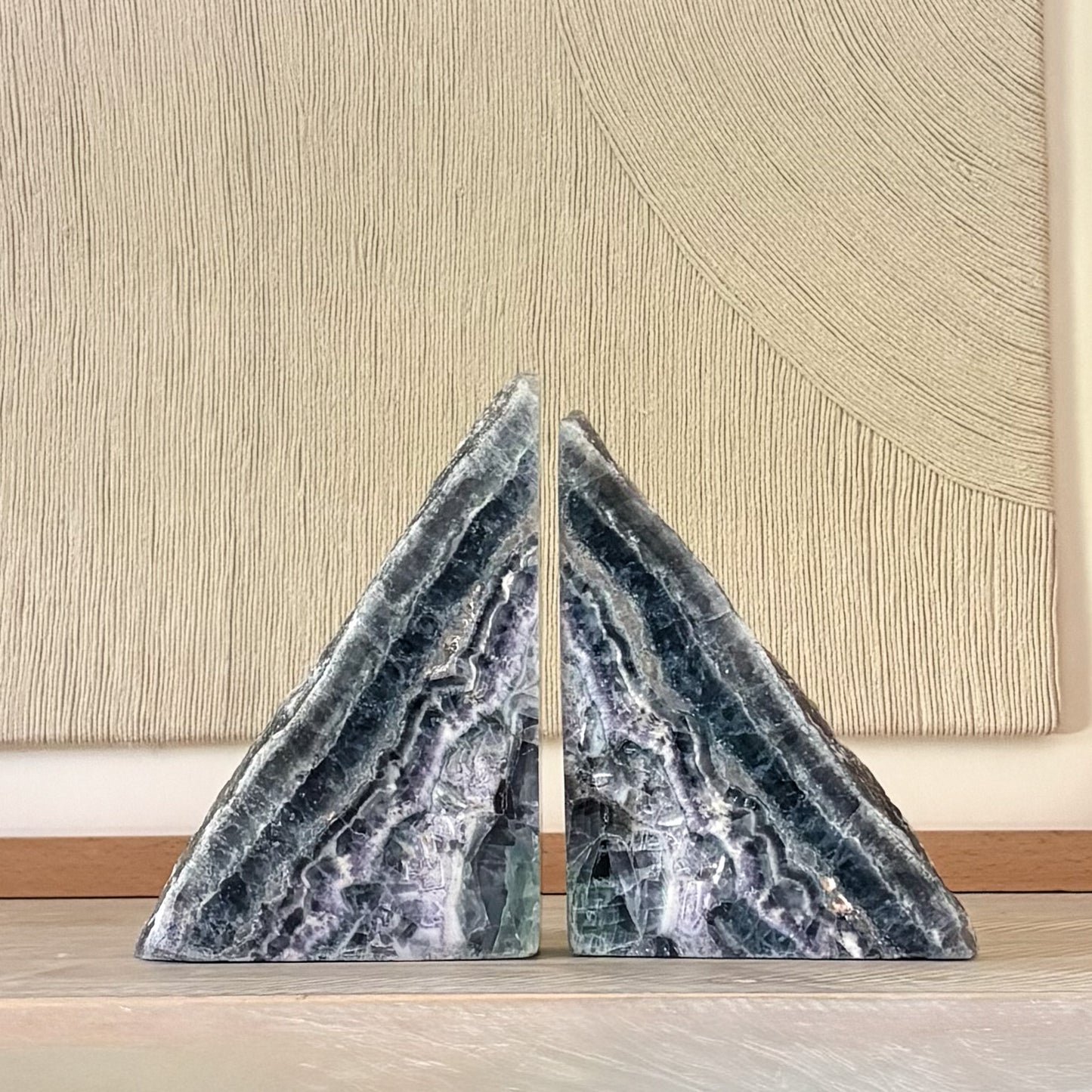 Colorful fluorite gemstone bookends displayed with hardcover books