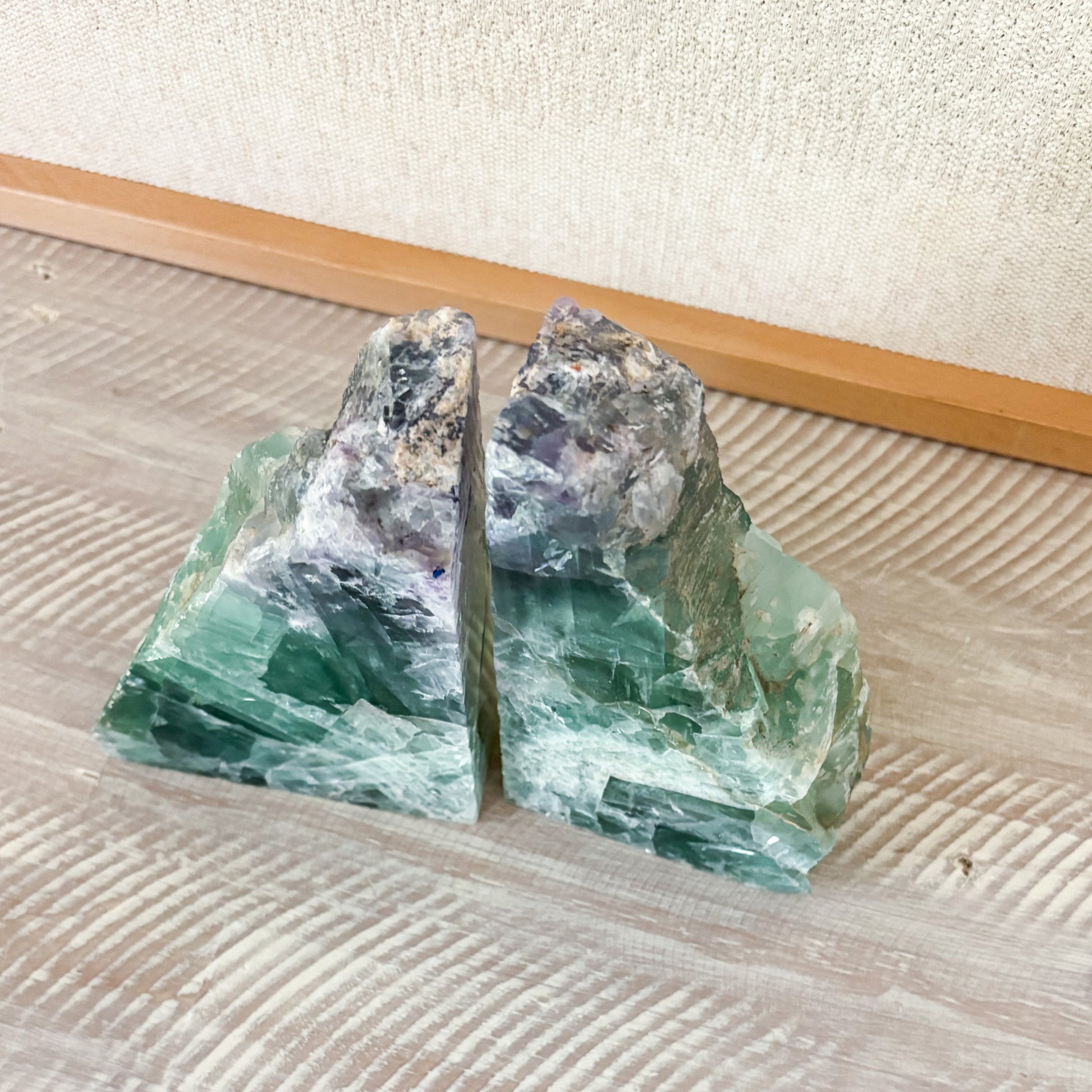 Large fluorite crystal bookends with polished surfaces and unique multicolored mineral patterns