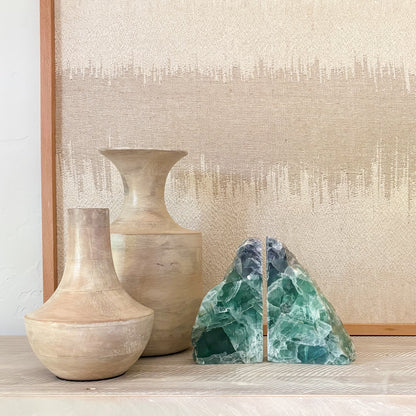 Pair of polished rainbow fluorite crystal bookends with natural banding and vibrant purple, green, and blue hues
