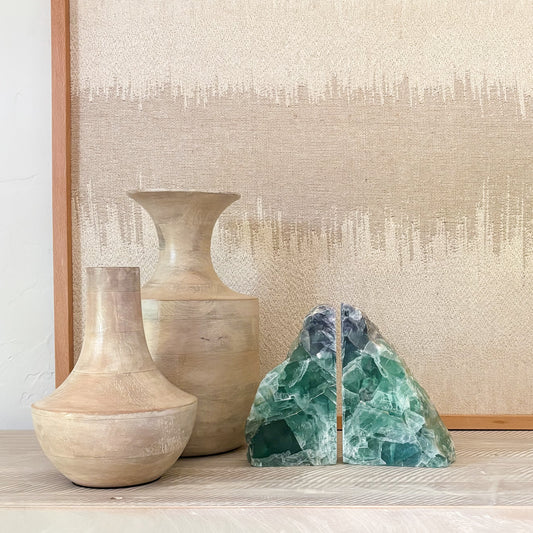 Pair of polished rainbow fluorite crystal bookends with natural banding and vibrant purple, green, and blue hues