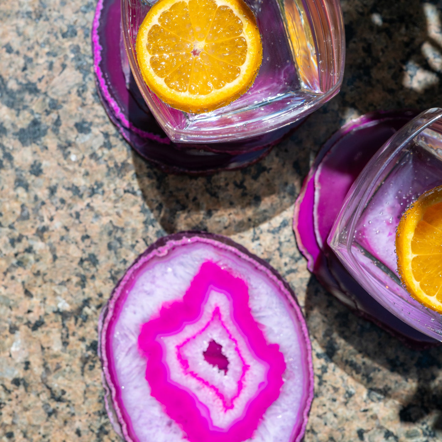 One-of-a-kind fuchsia agate coaster set featuring vibrant gemstone colors and natural banding for sophisticated home décor.